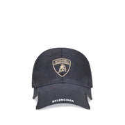 Black cap with Lamborghini logo and Balenciaga branding on a white background
