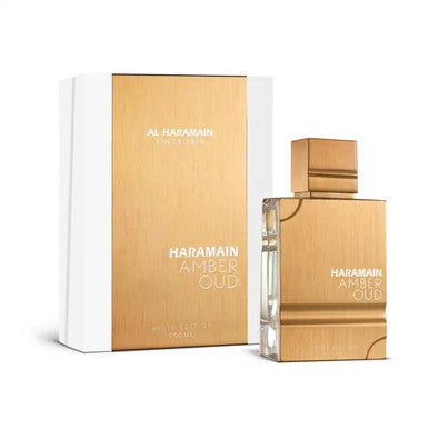 A product image featuring a white box and bottle of AL HARAMAIN Amber Oud White Edition Eau de Parfum Spray.