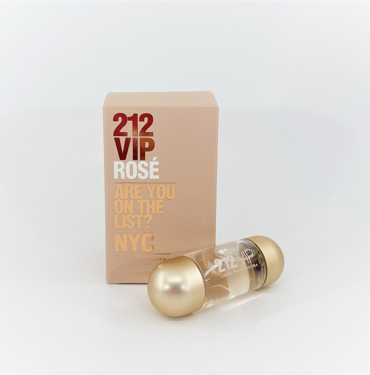A sealed box of 212 VIP ROSE eau de parfum by Carolina Herrera with a small glass bottle in front.