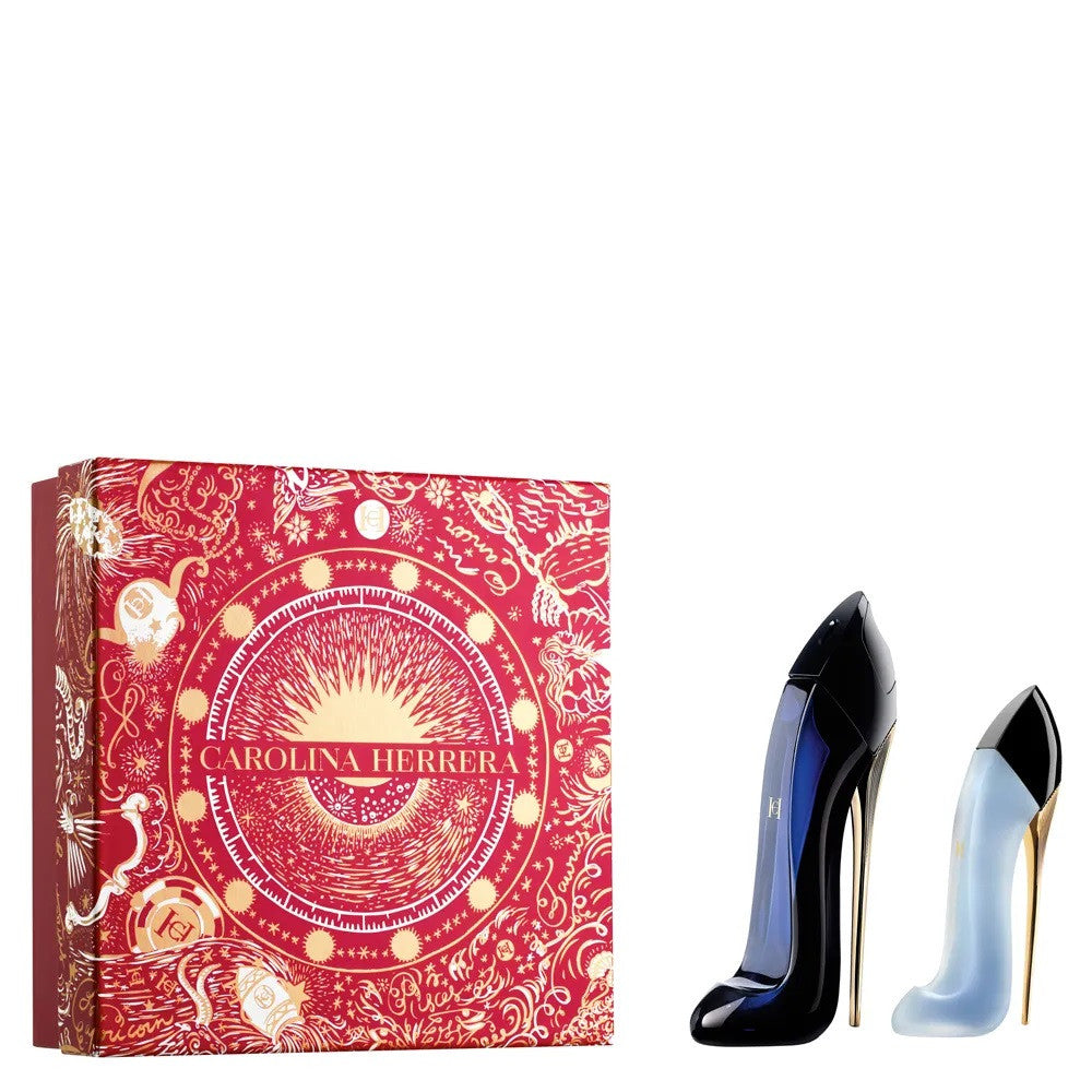 A product image featuring a CAROLINA HERRERA Good Girl fragrance set containing a 2.7 EAU DE PARFUM SPRAY and 1 oz HAIR MIST, displayed next to its red packaging with gold and white designs.