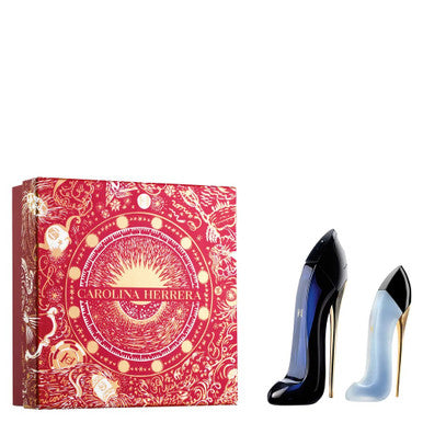 A product image featuring a CAROLINA HERRERA Good Girl fragrance set containing a 2.7 EAU DE PARFUM SPRAY and 1 oz HAIR MIST, displayed next to its red packaging with gold and white designs.