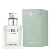 A bottle of ETERNITY cologne for men by Calvin Klein, accompanied by its green box packaging. The cologne bottle is transparent, revealing a light-colored liquid, with a silver cap.