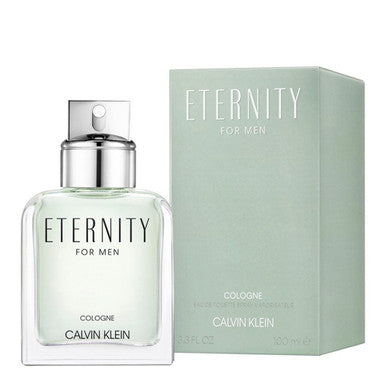 A bottle of ETERNITY cologne for men by Calvin Klein, accompanied by its green box packaging. The cologne bottle is transparent, revealing a light-colored liquid, with a silver cap.