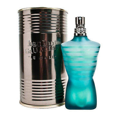 A bottle of Jean Paul Gaultier Le Male 2.5 Eau de Toilette spray for men, with a distinctive turquoise liquid visible inside the clear bottle, alongside its cylindrical metallic packaging.