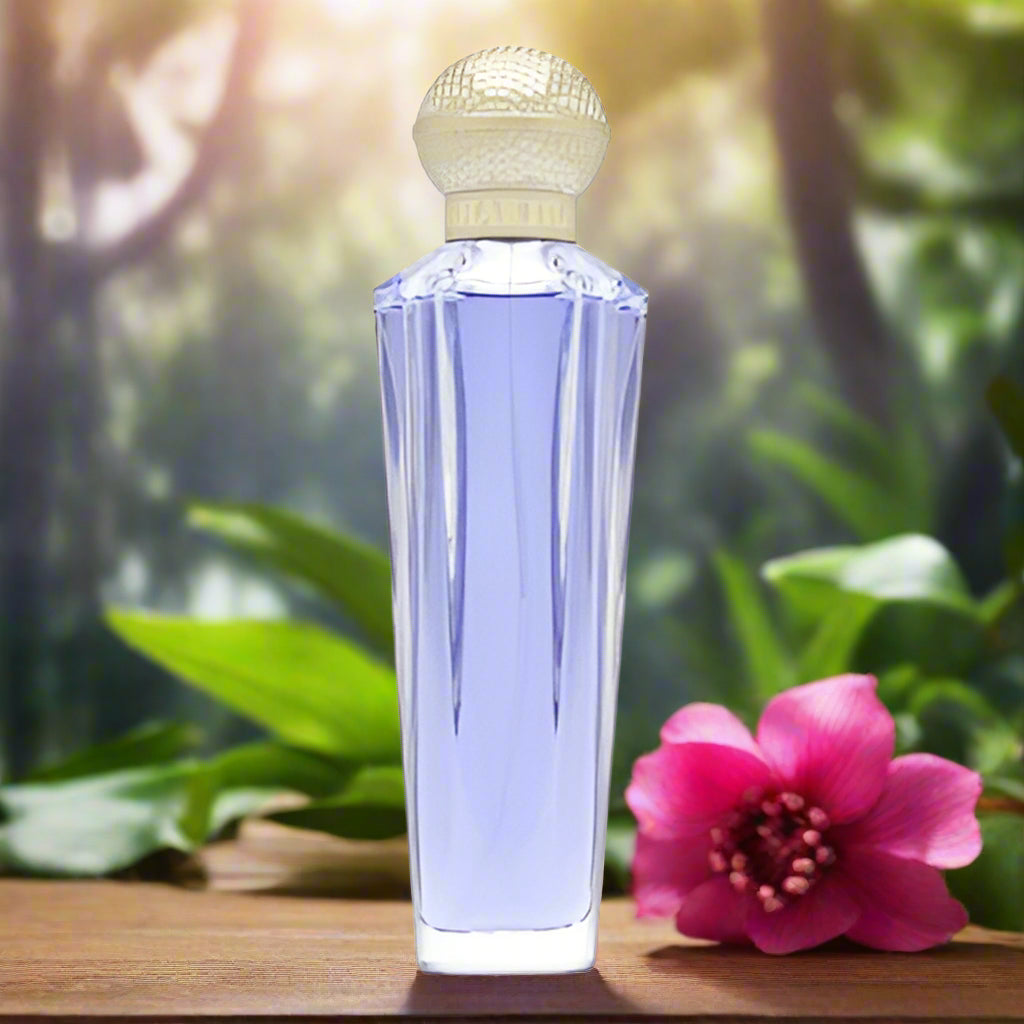 A clear glass spray bottle of SHAKIRA DREAM TESTER 2.7 EAU DE TOILETTE for women, with visible purple liquid inside and a golden cap.