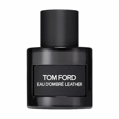 A black bottle of TOM FORD EAU D'OMBRE LEATHER EAU DE TOILETTE SPRAY with a white label.