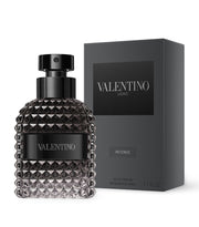 A black bottle of VALENTINO UOMO INTENSE EAU DE PARFUM SPRAY with a textured design, displayed next to its black box packaging.