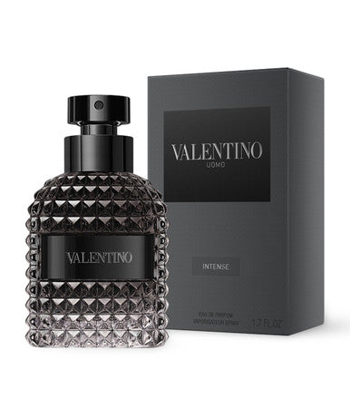 A black bottle of VALENTINO UOMO INTENSE EAU DE PARFUM SPRAY with a textured design, displayed next to its black box packaging.