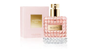 A spray bottle of VALENTINO DONNA 1.7 EAU DE PARFUM, with a pink label and a clear cap, alongside its pink box packaging.