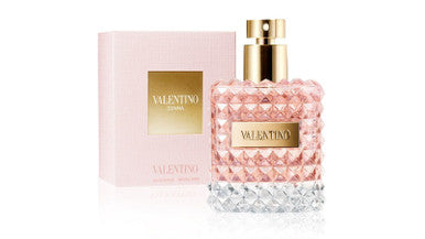 A spray bottle of VALENTINO DONNA 1.7 EAU DE PARFUM, with a pink label and a clear cap, alongside its pink box packaging.