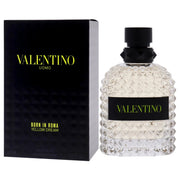 VALENTINO UOMO BORN IN ROMA YELLOW DREAM eau de toilette spray bottle next to its black box packaging with gold accents.