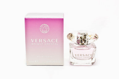 A mini bottle of VERSACE BRIGHT CRYSTAL EAU DE TOILETTE next to its pink box, both displaying the VERSACE brand logo.