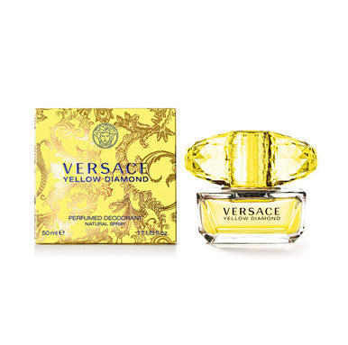 A product image featuring VERSACE YELLOW DIAMOND perfumed deodorant spray with a clear, yellow-colored bottle and a decorative yellow box with floral patterns. The VERSACE logo is prominently displayed on both the bottle and box.