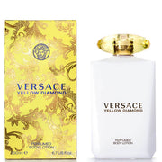 A bottle of VERSACE YELLOW DIAMOND body lotion next to its packaging box. The bottle is white with a gold cap, and the box features a yellow design with leaf patterns and the VERSACE logo.