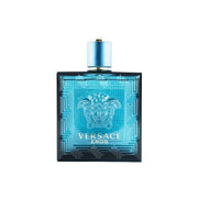 A blue glass bottle of VERSACE EROS eau de toilette spray for men with a metal cap and Versace branding.