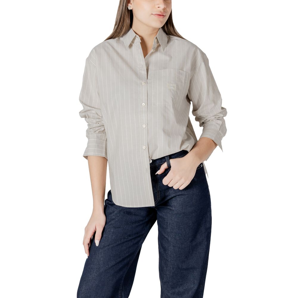 Striped button-down shirt and dark jeans styled with Calvin Klein Jeans Beige Cotton Sweater