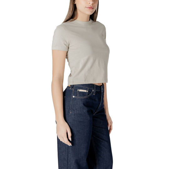 Woman wearing Calvin Klein Jeans beige cotton top and dark denim jeans outfit