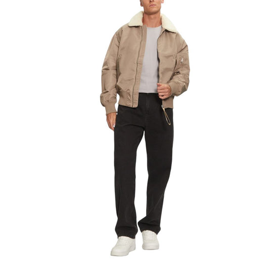 Man wearing Calvin Klein Jeans Beige Polyamide Riciclata Jacket and black pants