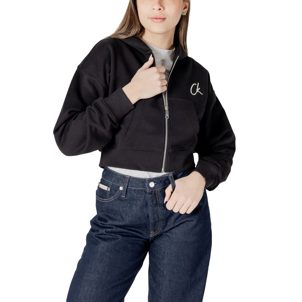 Woman in black cropped zip-up hoodie and jeans from Calvin Klein Jeans Black Cotton Sweater