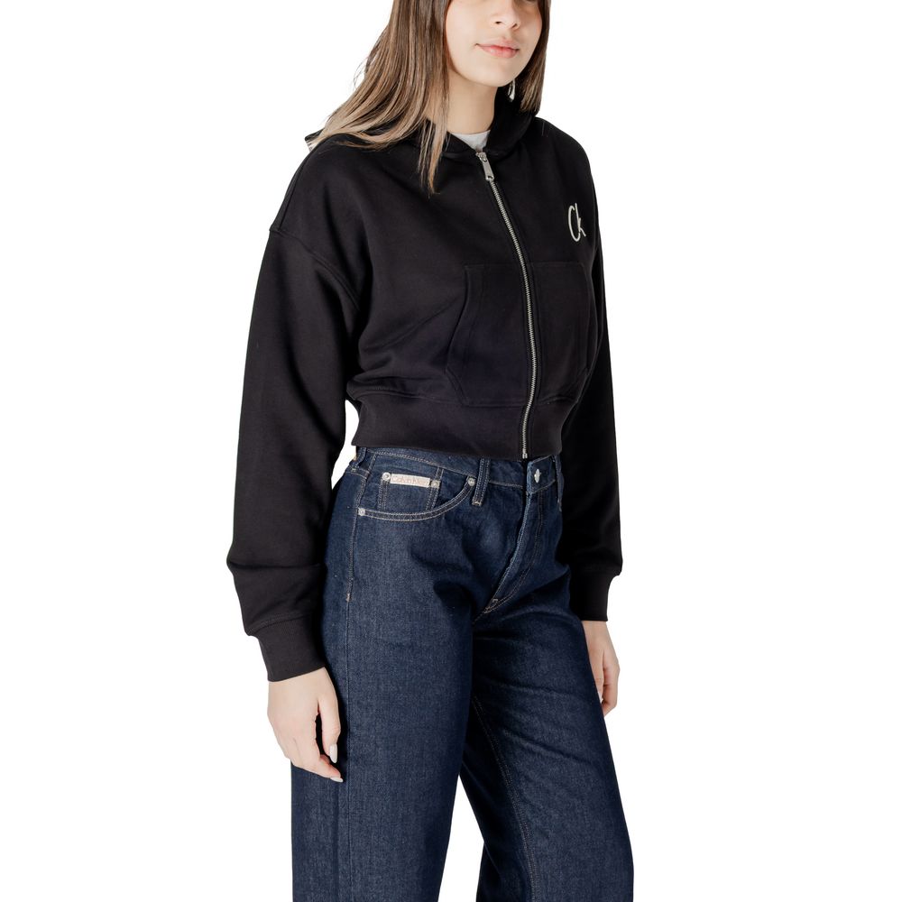 Woman wearing Calvin Klein Jeans black cotton sweater with dark denim jeans