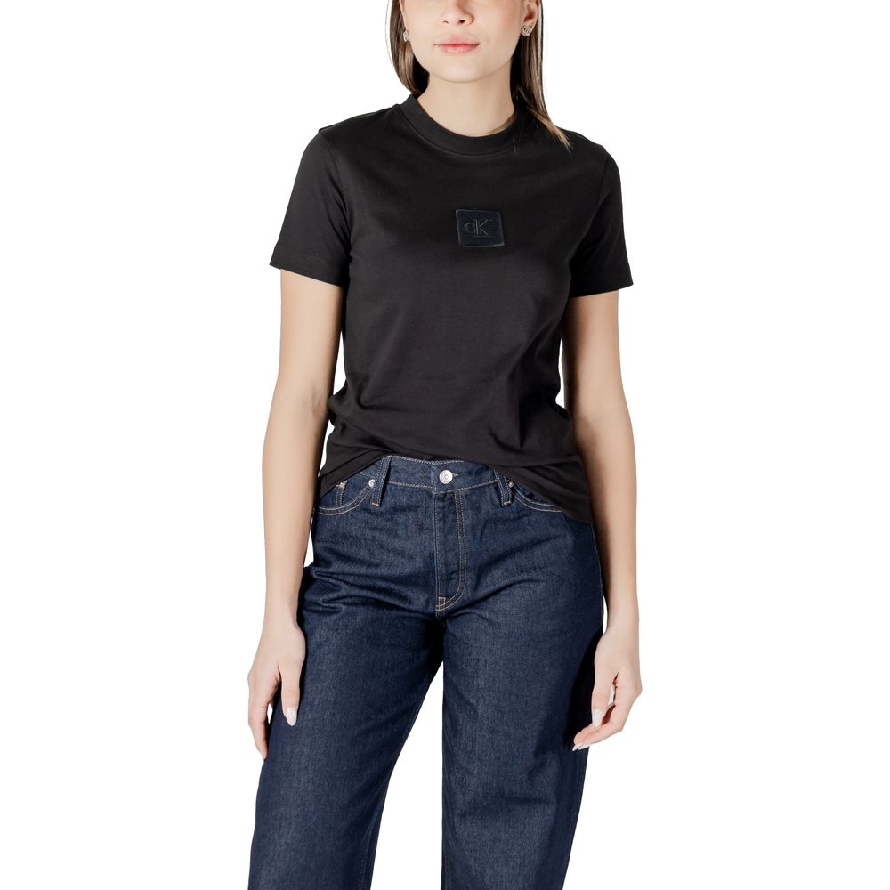 Woman in black cotton top and dark blue jeans from Calvin Klein Jeans collection