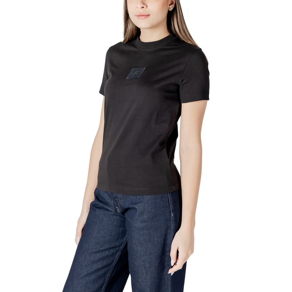Woman’s Calvin Klein Jeans black cotton tops t-shirt paired with blue jeans