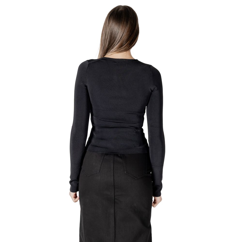 Woman in black long-sleeved shirt and skirt from Calvin Klein Jeans Black Rayon Tops