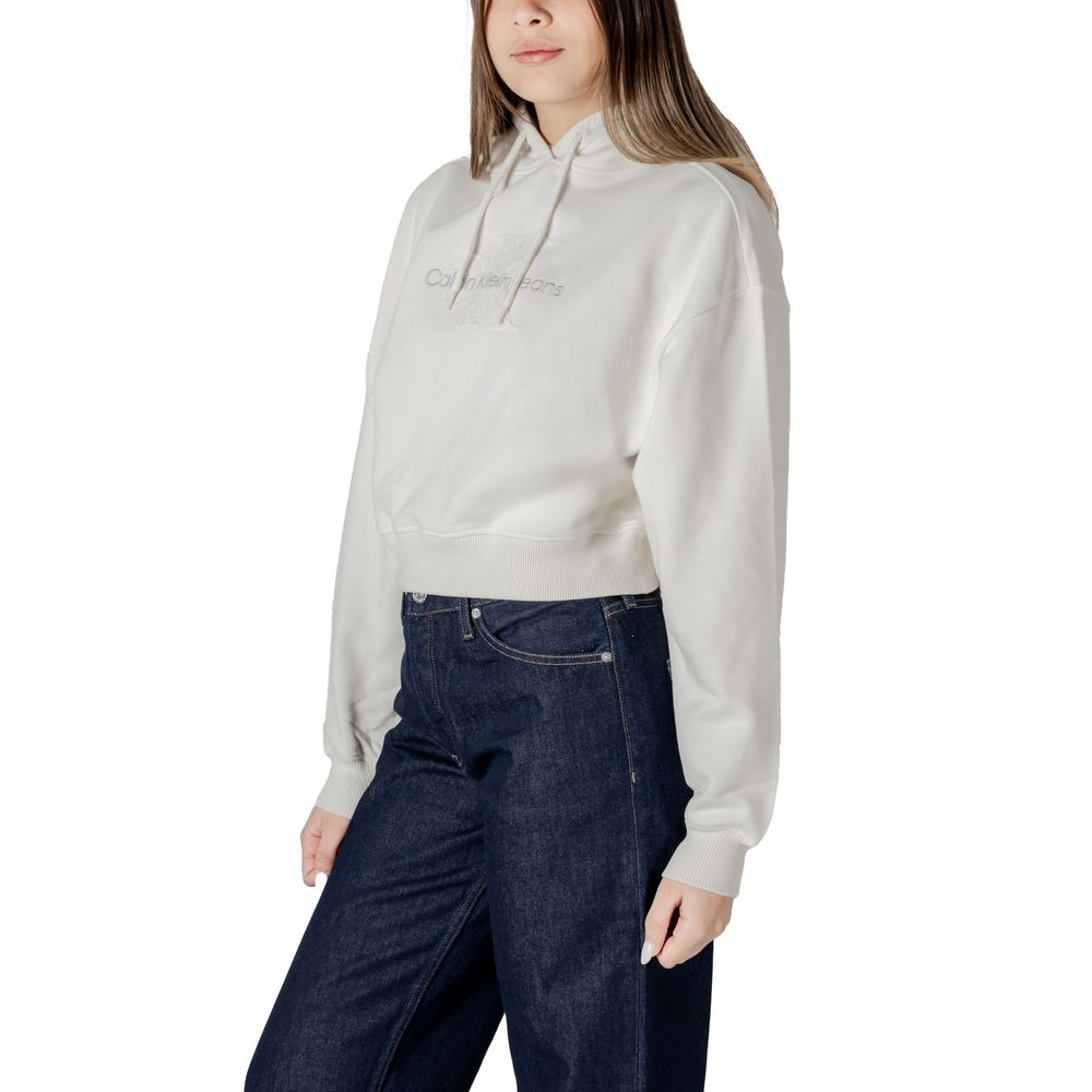 Woman in a light gray hoodie and dark blue jeans with a Calvin Klein Jeans Cream Cotton Sweater
