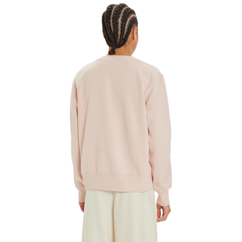 Person wearing a Calvin Klein Jeans pink cotton sweater in a stylish pose