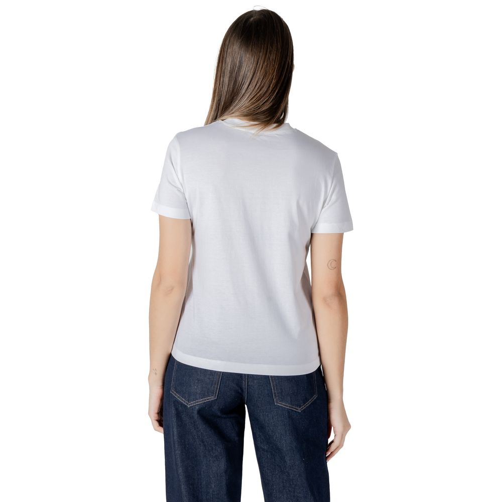 Woman in a Calvin Klein Jeans white cotton rigenerato top and dark blue jeans