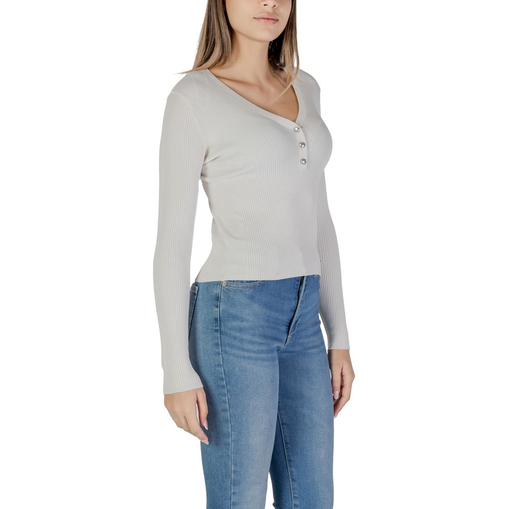 Woman’s long-sleeved ribbed Guess Cream Viscose top showcasing stylish comfort