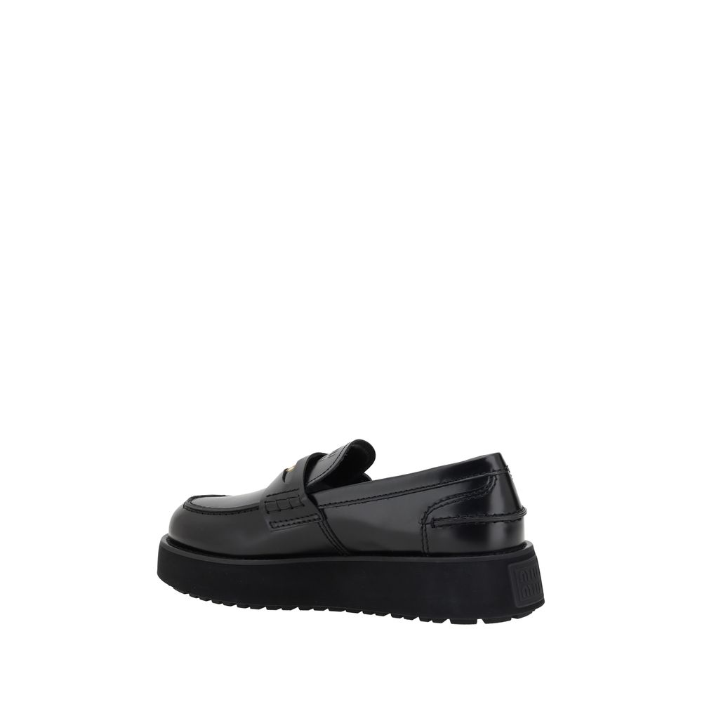 Black leather platform loafer from Miu Miu Leather Loafers collection, stylish and versatile