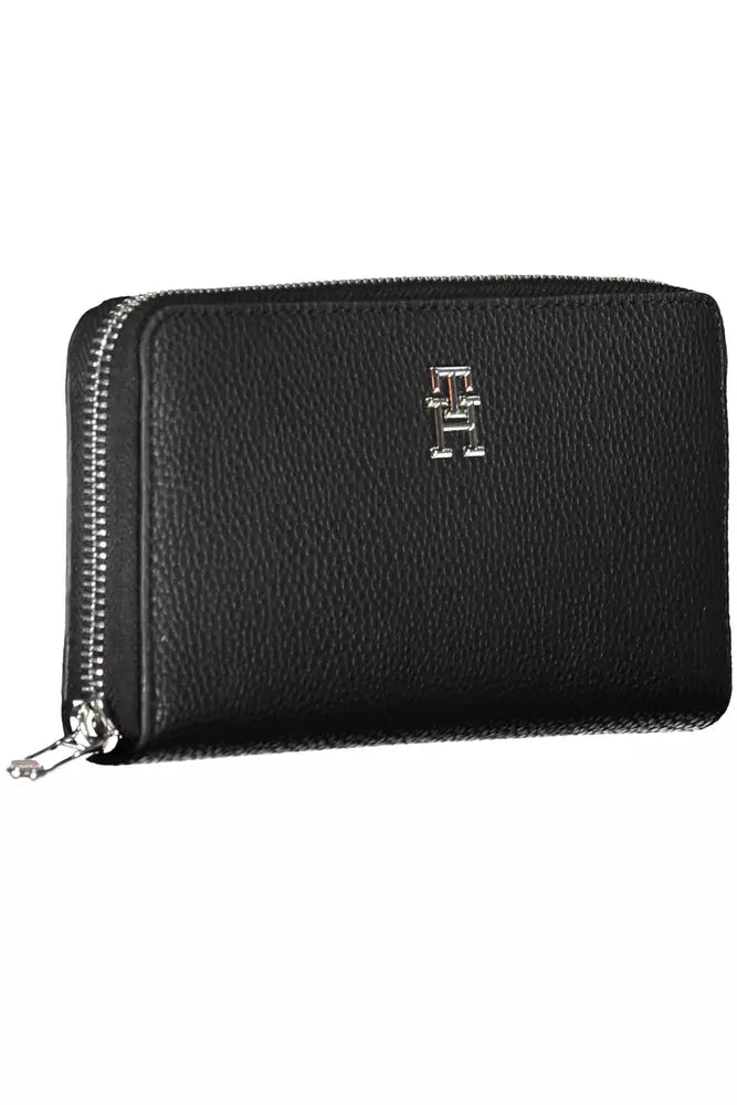 Black wallet by Tommy Hilfiger with silver logo and zippered closure