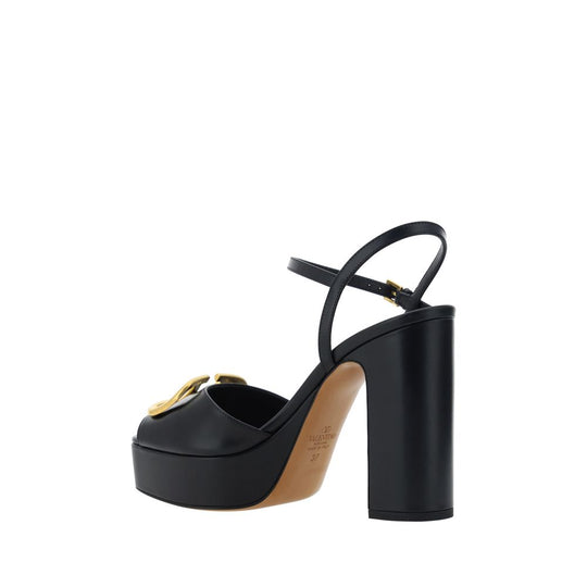 Black platform sandals with gold buckle from Valentino Garavani Logoed Sandals collection