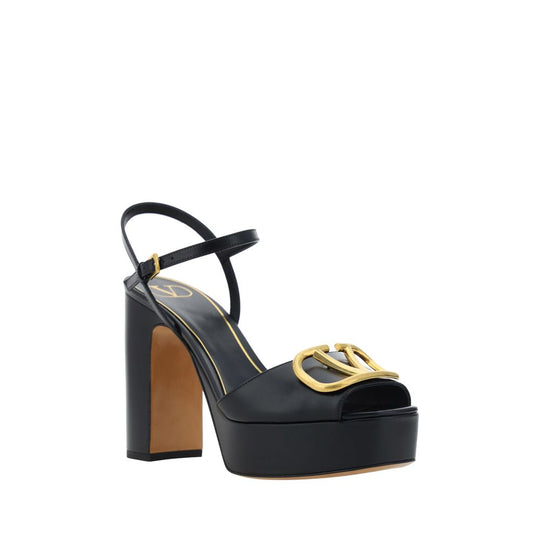 Black platform sandal with gold logo from Valentino Garavani Logoed Sandals collection