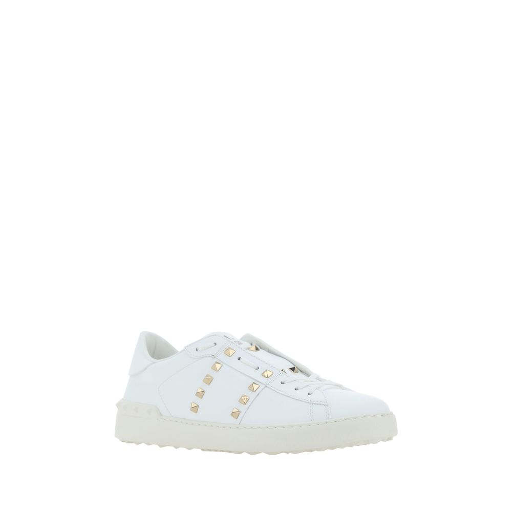 White leather Valentino Garavani Rockstud Sneakers featuring gold studs for stylish flair